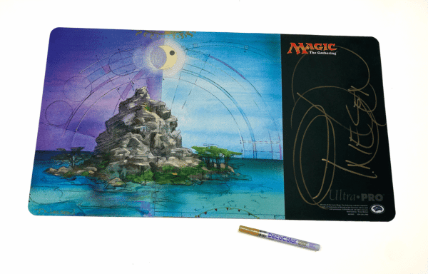 Angled Shot Of MTG Island Playmat With Gold Pen